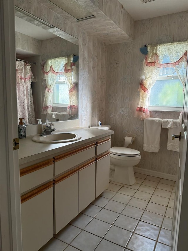 1695 Stable Trl, Palm Harbor, FL 34685 - full bath featuring vanity, tile patterned floors, a wealth of natural light, and toilet