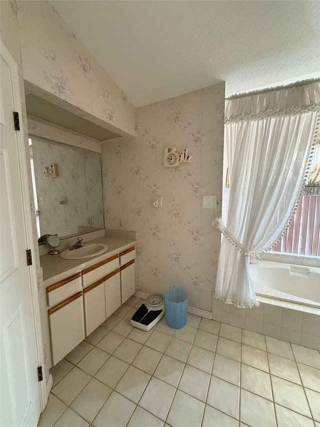 1695 Stable Trl, Palm Harbor, FL 34685 - bathroom with vanity, tile patterned flooring, wallpapered walls, and a relaxing tiled tub