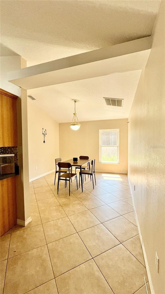 dining room featuring light tile patterned floors, baseboards, and visible vents