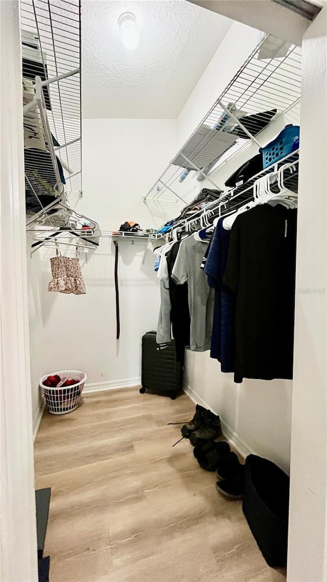 spacious closet with wood finished floors