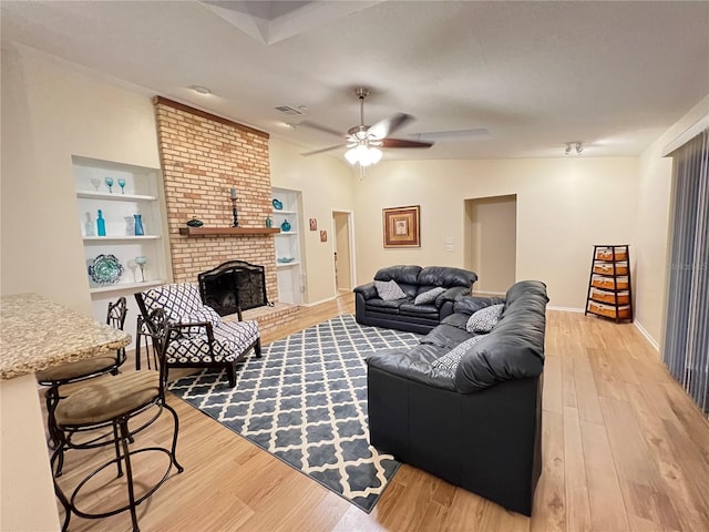 3907 Applegate Cir, Brandon, FL 33511 - living area featuring ceiling fan, light wood-type flooring, and a brick fireplace