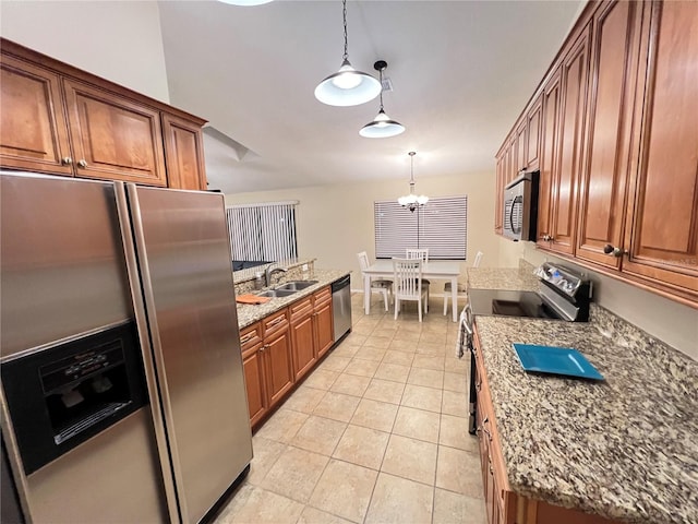 3907 Applegate Cir, Brandon, FL 33511 - kitchen with appliances with stainless steel finishes, brown cabinetry, decorative light fixtures, and light stone countertops