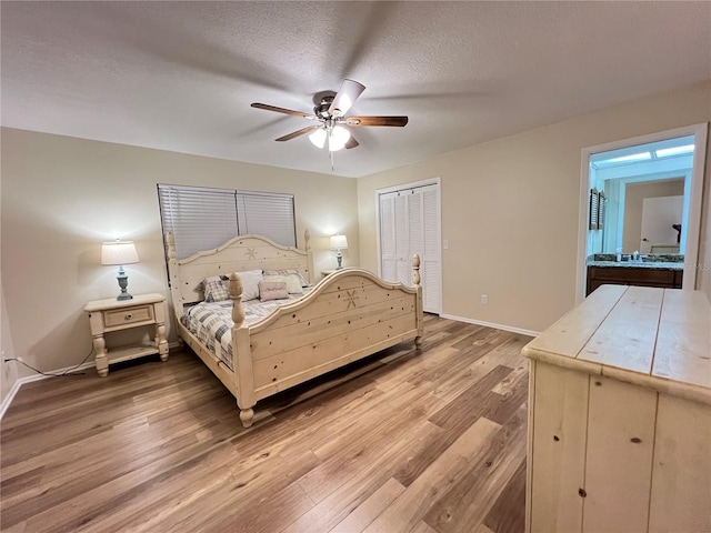 3907 Applegate Cir, Brandon, FL 33511 - bedroom featuring wood finished floors, a closet, a ceiling fan, and a textured ceiling