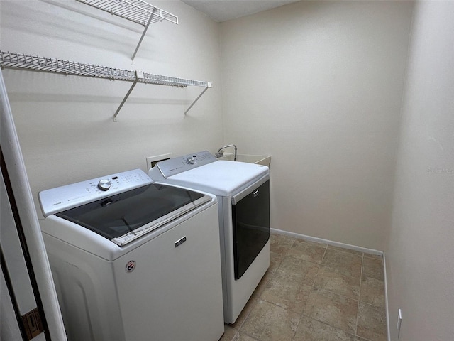 3907 Applegate Cir, Brandon, FL 33511 - washroom featuring washing machine and clothes dryer and light stone finish floors