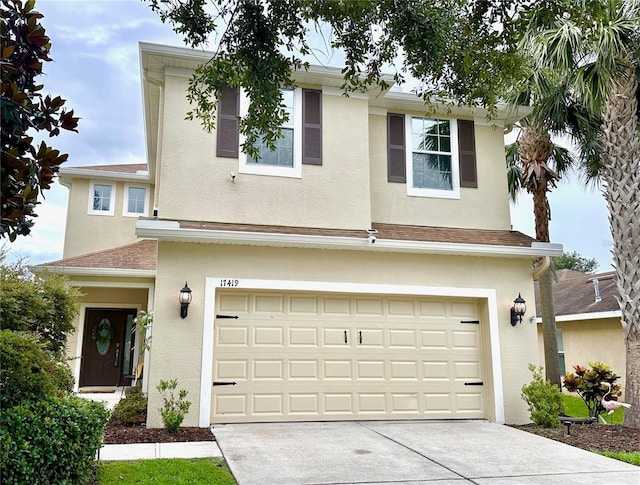 17419 New Cross Cir, Lithia, FL 33547 - traditional-style house featuring stucco siding, an attached garage, driveway, and a shingled roof