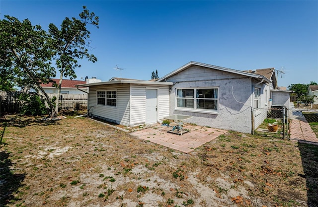 7420 Cay Dr, Port Richey, FL 34668 - rear view of property with a gate, a fenced backyard, a patio area, and stucco siding