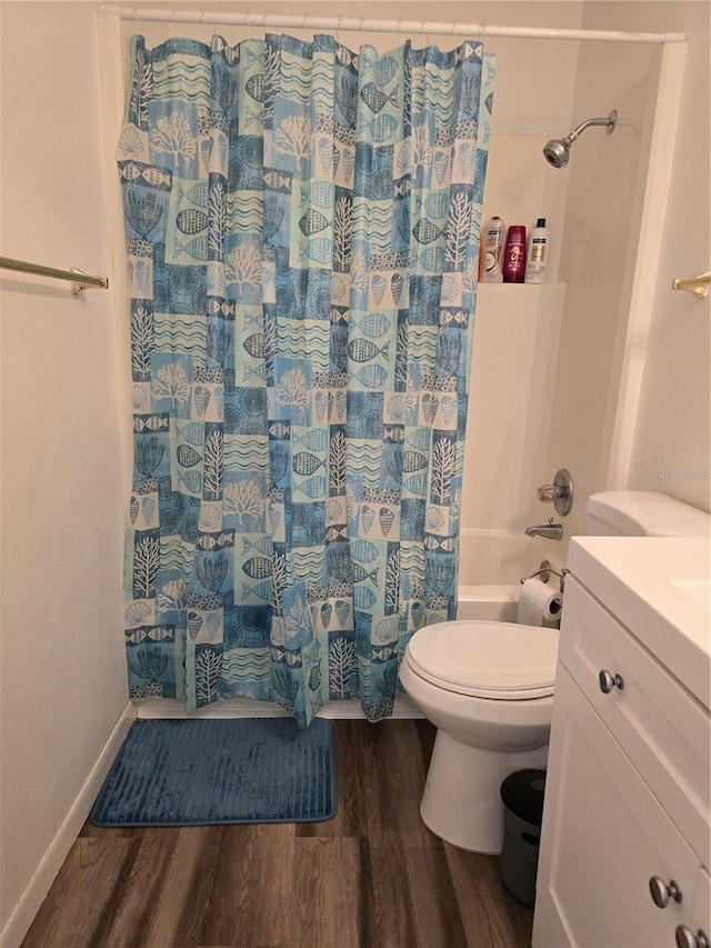 full bathroom with vanity, baseboards, shower / bath combination with curtain, toilet, and wood finished floors