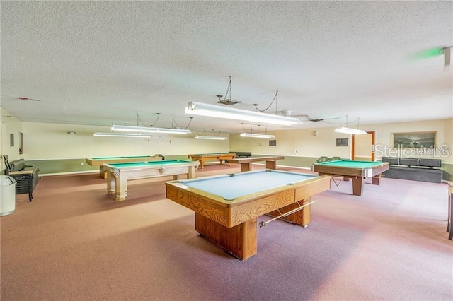 rec room with carpet flooring, a textured ceiling, and billiards
