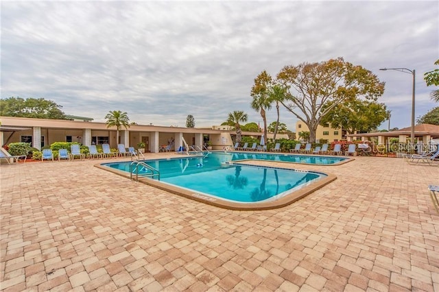 community pool with a patio area