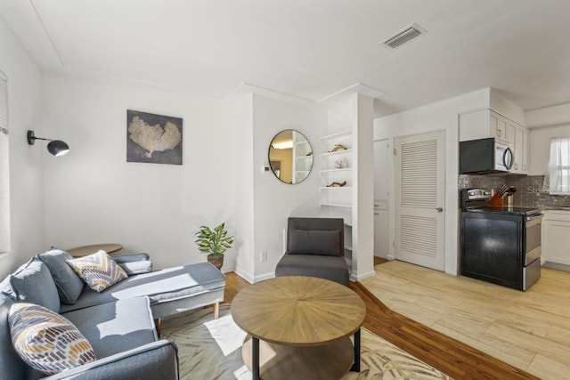 3600 46th St N, Saint Petersburg, FL 33713 - living room featuring light wood-style flooring and visible vents