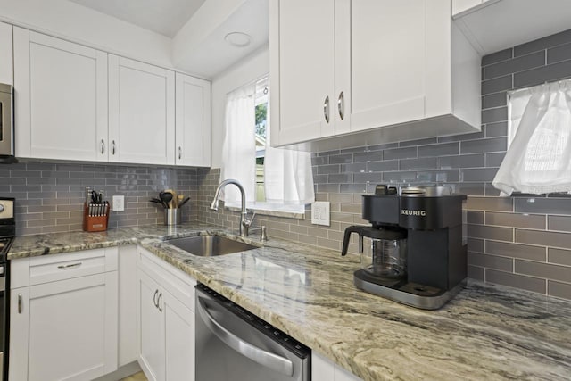 3600 46th St N, Saint Petersburg, FL 33713 - kitchen with decorative backsplash, appliances with stainless steel finishes, light stone countertops, a sink, and white cabinets