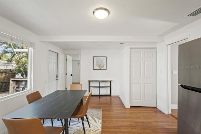 3600 46th St N, Saint Petersburg, FL 33713 - dining space with visible vents, light wood finished floors, and baseboards