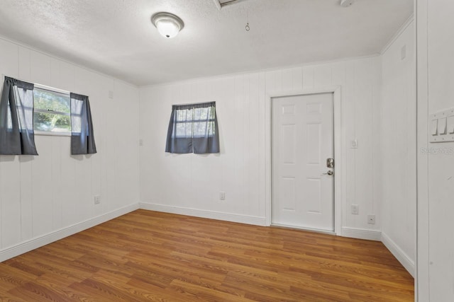 3600 46th St N, Saint Petersburg, FL 33713 - empty room with a textured ceiling, baseboards, and wood finished floors