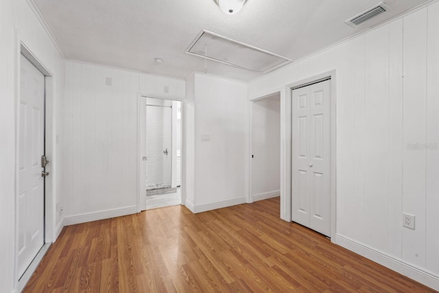 3600 46th St N, Saint Petersburg, FL 33713 - unfurnished bedroom featuring crown molding, attic access, wood finished floors, and visible vents