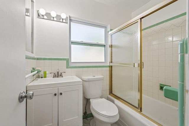 3600 46th St N, Saint Petersburg, FL 33713 - bathroom with vanity, toilet, shower / bath combination with glass door, and tile walls