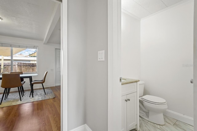 3600 46th St N, Saint Petersburg, FL 33713 - bathroom with crown molding, toilet, baseboards, and vanity