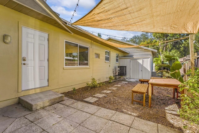 3600 46th St N, Saint Petersburg, FL 33713 - exterior space with a patio, cooling unit, an outbuilding, and a shed