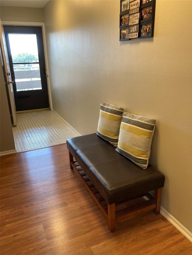 hall with wood finished floors and baseboards