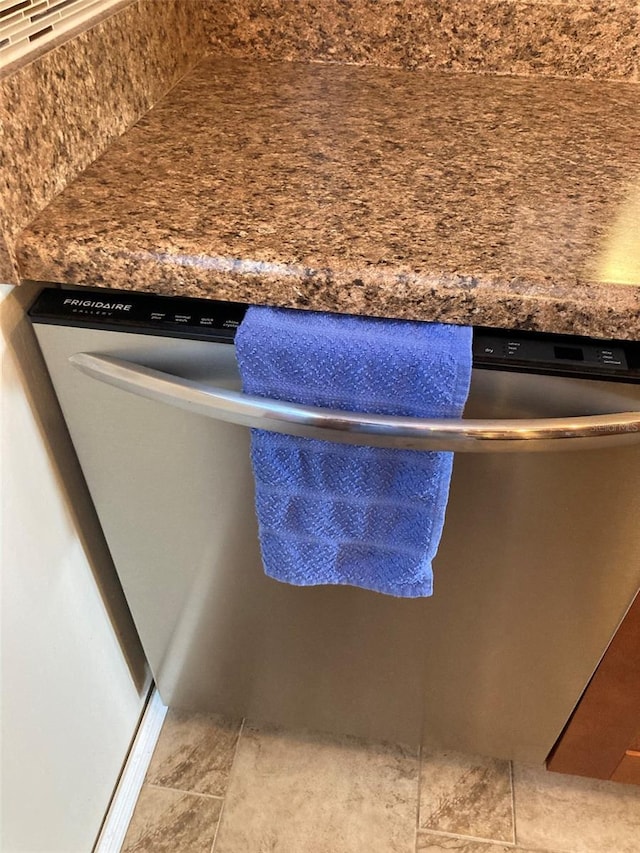 kitchen view of dishwasher and backsplash