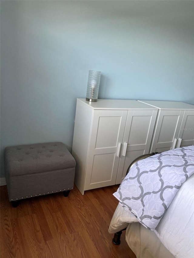 bedroom with dark wood finished floors