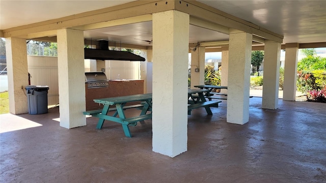 view of patio with an outdoor kitchen, outdoor dining space, and grilling area
