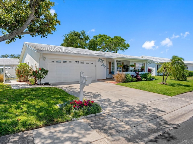 9110 34th Way N, Pinellas Park, FL 33782 - ranch-style house with an attached garage, driveway, a front lawn, and stucco siding