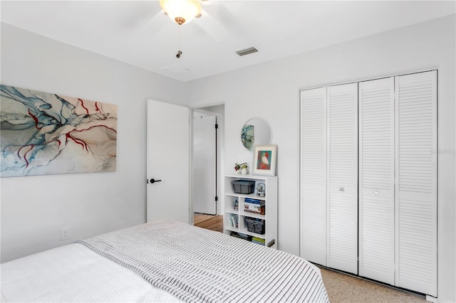 bedroom with a ceiling fan, visible vents, and a closet