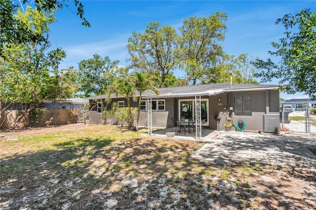 back of house with fence and a patio