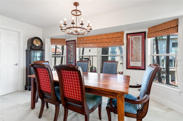 dining area with baseboards and a chandelier