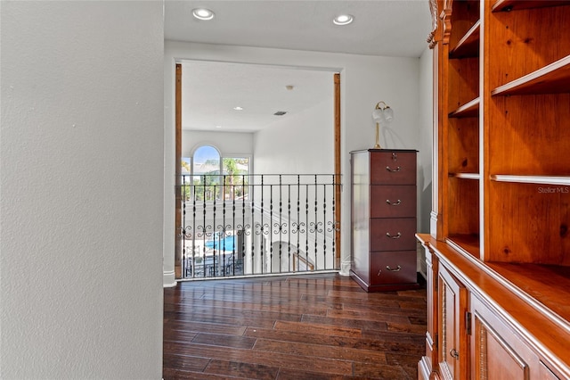 corridor featuring dark wood-type flooring and recessed lighting