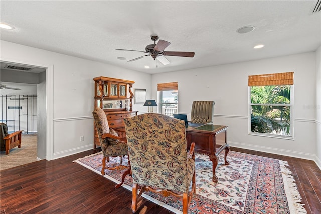 office area featuring a textured ceiling, baseboards, visible vents, ceiling fan, and hardwood / wood-style flooring