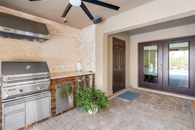 view of patio featuring french doors, an outdoor kitchen, and ceiling fan