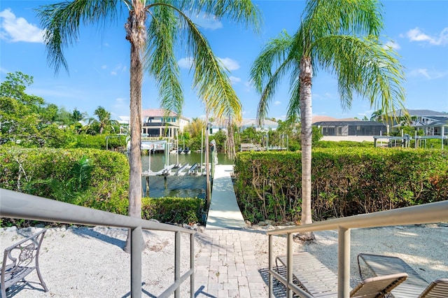 view of home's community featuring boat lift, a boat dock, and a water view