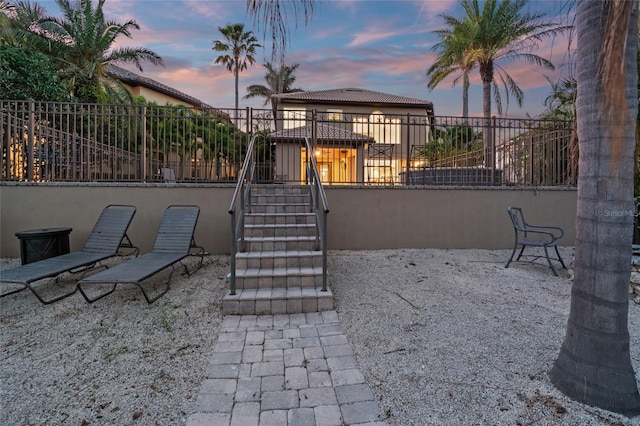 patio terrace at dusk with fence and stairway