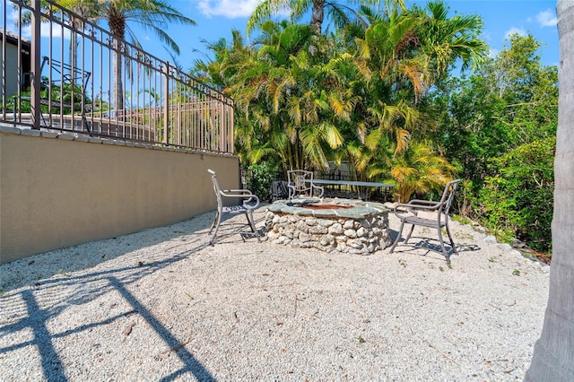 view of yard with a patio, an outdoor fire pit, and fence
