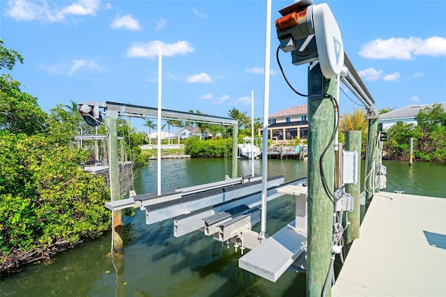 view of dock featuring boat lift and a water view