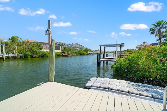 view of dock featuring boat lift and a water view