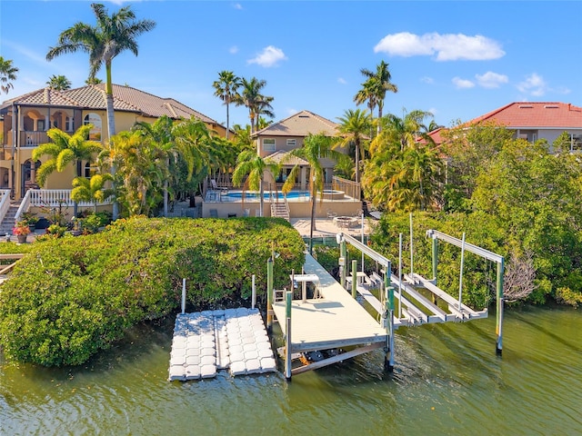 dock area featuring an outdoor pool, boat lift, and a water view