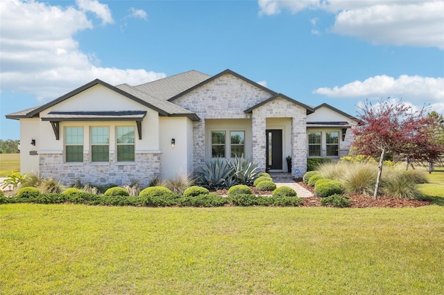 view of front of house with stucco siding, a front lawn, and stone siding
