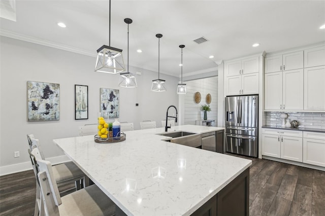 kitchen with a sink, dark wood-style flooring, visible vents, appliances with stainless steel finishes, and ornamental molding