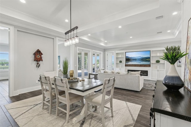 dining space with recessed lighting, a tray ceiling, visible vents, ornamental molding, and dark wood-style flooring
