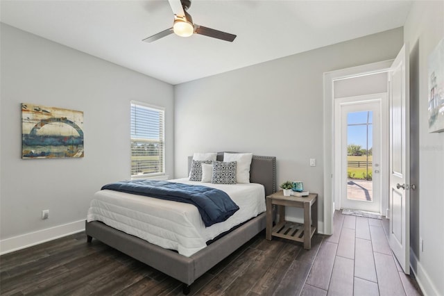 bedroom featuring dark wood-type flooring, a ceiling fan, baseboards, and access to outside