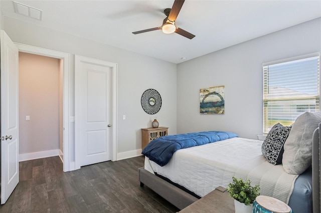 bedroom with baseboards, visible vents, dark wood-type flooring, and ceiling fan