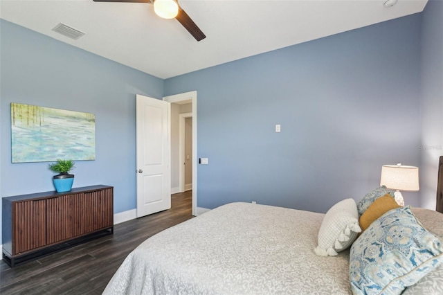 bedroom with radiator heating unit, wood finished floors, visible vents, baseboards, and ceiling fan