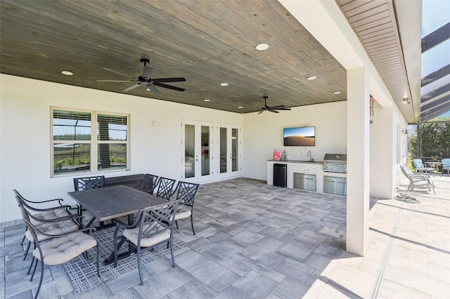 view of patio / terrace featuring exterior kitchen, french doors, area for grilling, and a ceiling fan
