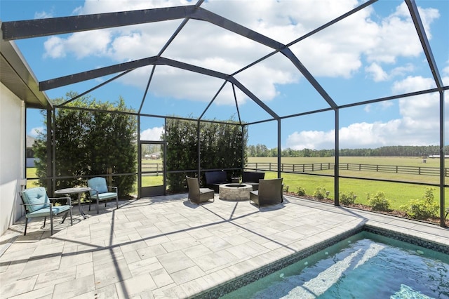 view of patio / terrace with an outdoor pool, a rural view, glass enclosure, and an outdoor fire pit