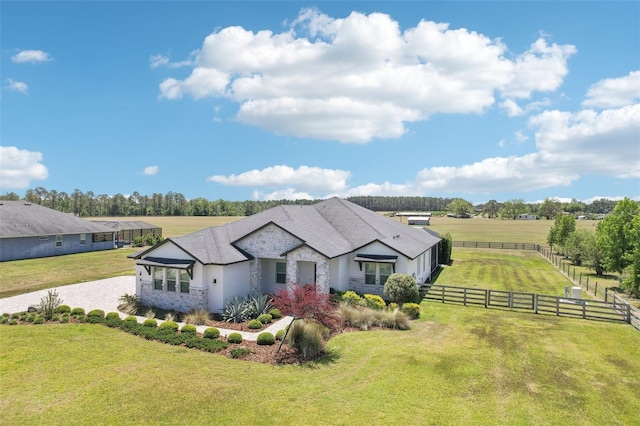 exterior space featuring fence, a rural view, and a front yard