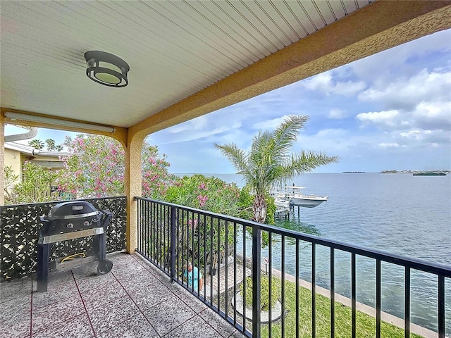 balcony featuring a water view and a grill