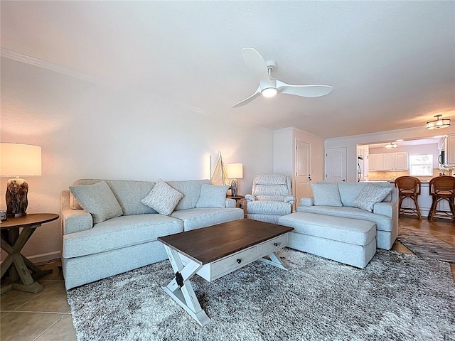 living area featuring light tile patterned floors and ceiling fan