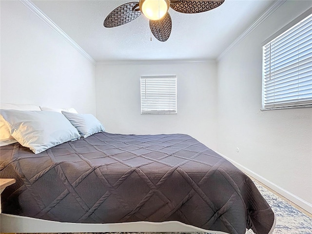 bedroom with baseboards, ornamental molding, and multiple windows